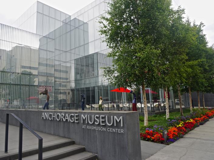 view of anchorage museum in alaska, with gray walkway and lots of windows