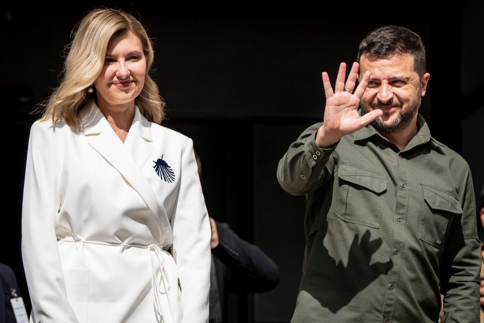 Ukrainian president Volodymyr Zelensky reacts while standing next to his wife Olena Zelenska in front of the Danish Parliament in Copenhagen (EPA)