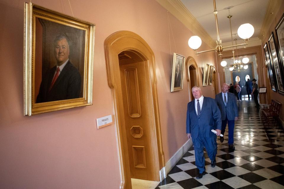 Rep. Larry Householder walks past his portrait as a former Ohio House speaker after he was expelled from the Ohio House at the Ohio Statehouse in Columbus on June 16, 2021.