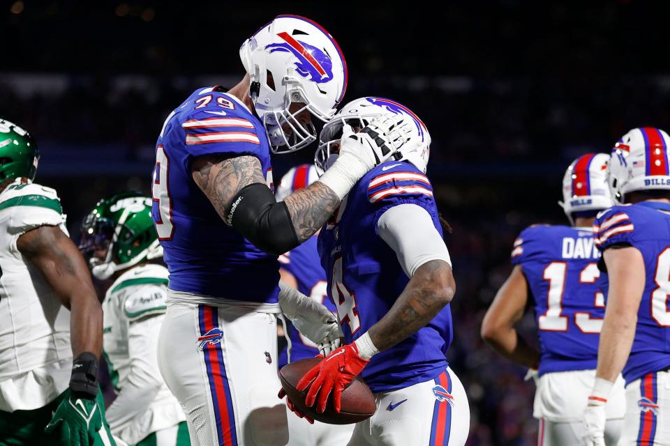 Spencer Brown and James Cook celebrate in the second quarter against the New York Jets at Highmark Stadium.