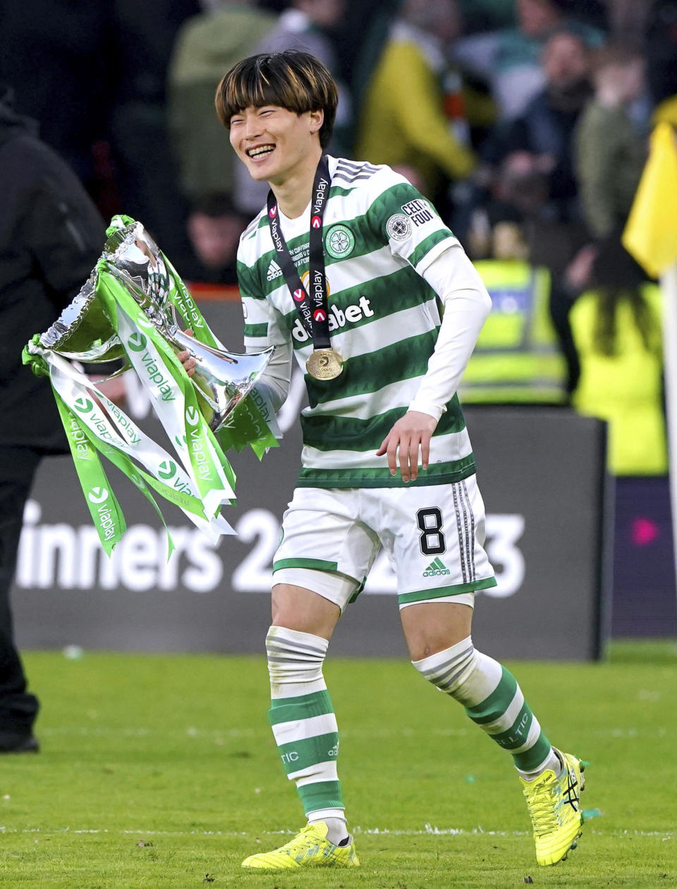 Celtic's Kyogo Furuhashi celebrates with the cup after the Scottish League Cup Final against Rangers at Hampden Park, Glasgow, Scotland, Sunday Feb. 26, 2023. (Andrew Milligan/PA via AP)