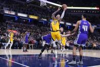 Indiana Pacers' Daniel Theis (27) is fouled by Sacramento Kings' Domantas Sabonis as he goes up for a shot during the second half of an NBA basketball game, Friday, Feb. 3, 2023, in Indianapolis. (AP Photo/Darron Cummings)