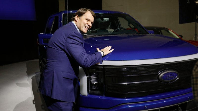 Ford CEO Jim Farley pats a Ford F-150 Lightning truck before announcing at a press conference that Ford Motor Company will be partnering with the world's largest battery company, a China-based company called Contemporary Amperex Technology, to create an electric-vehicle battery plant in Marshall, Michigan, on February 13, 2023 in Romulus, Michigan.