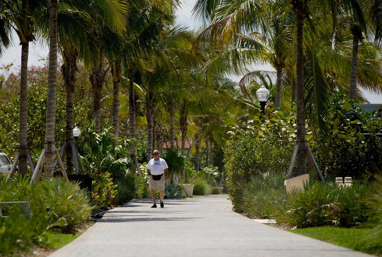 A pedestrian walks the trail at Lake Drive Park along the Intracoastal Waterway in March.