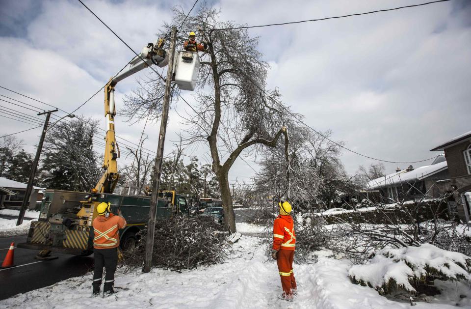 Toronto Hydro employees work to restore power in the Scarborough suburb following an ice storm in Toronto