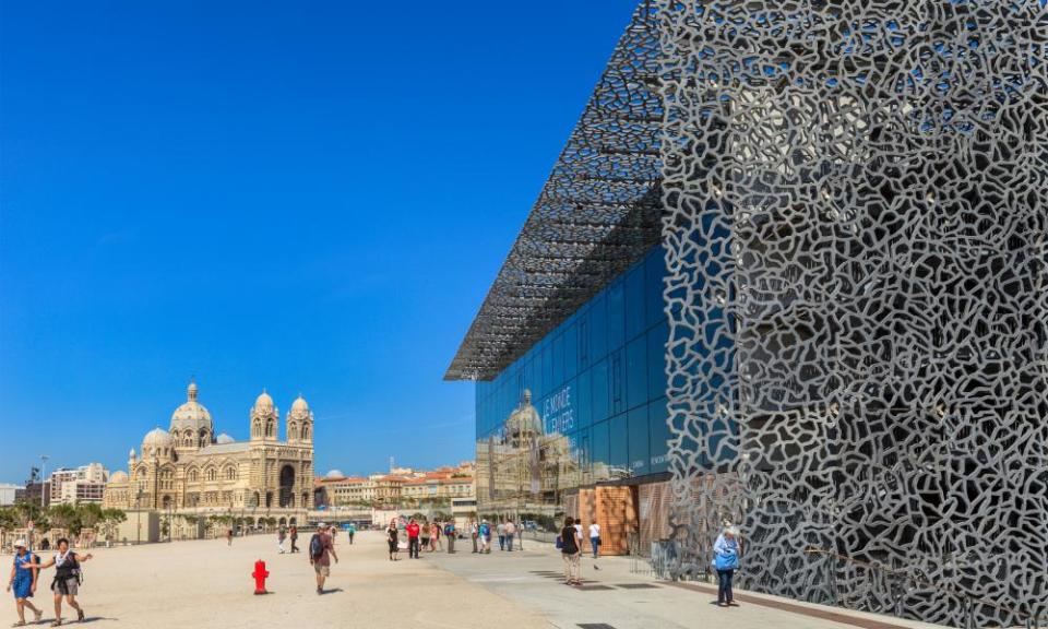 Tourists strolling on the promenade next to the MuCEM,