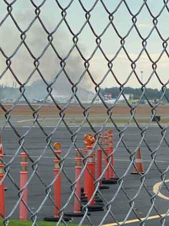 Smoke is seen from Windsor Locks at the site of an airplane crash in Bradley International Airport, Connecticut