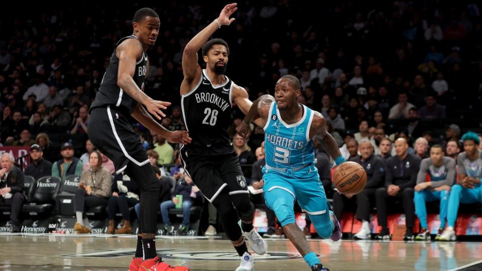 Mar 5, 2023; Brooklyn, New York, USA; Charlotte Hornets guard Terry Rozier (3) controls the ball against Brooklyn Nets center Nic Claxton (33) and guard Spencer Dinwiddie (26) during the first quarter at Barclays Center.