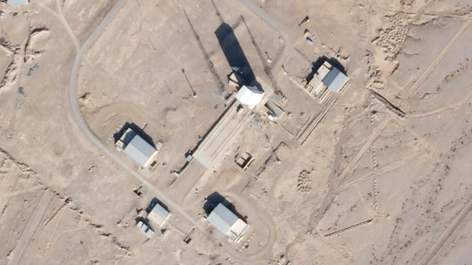 In this satellite photo by Planet Labs Inc., a support vehicle stands parked alongside a massive white gantry that typically houses a rocket on the launch pad as activity is seen at the Imam Khomeini Spaceport in Semnan province, Iran, Saturday, Dec. 11, 2021. Iran appears to be preparing for a space launch as negotiations continue in Vienna over its tattered nuclear deal with world powers, according to an expert and satellite images. (Planet Labs Inc. via AP)