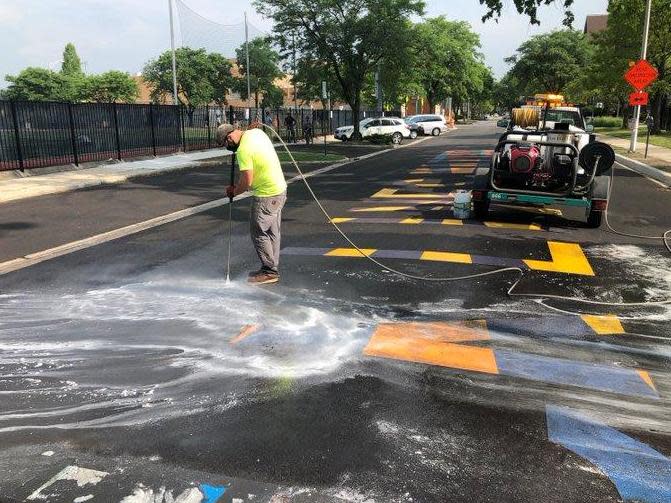 City workers in Oak Park cleaned a Black Lives Mural that was defaced on Tuesday night: Oak Park Police Department / Twitter