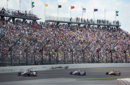 May 29, 2016; Indianapolis, IN, USA; IndyCar Series driver Alex Tagliani (35) , driver Alexander Rossi (98) and driver James Hinchcliffe (5) race in turn one during the 100th running of the Indianapolis 500 at Indianapolis Motor Speedway. Mandatory Credit: Michael Madrid-USA TODAY Sports