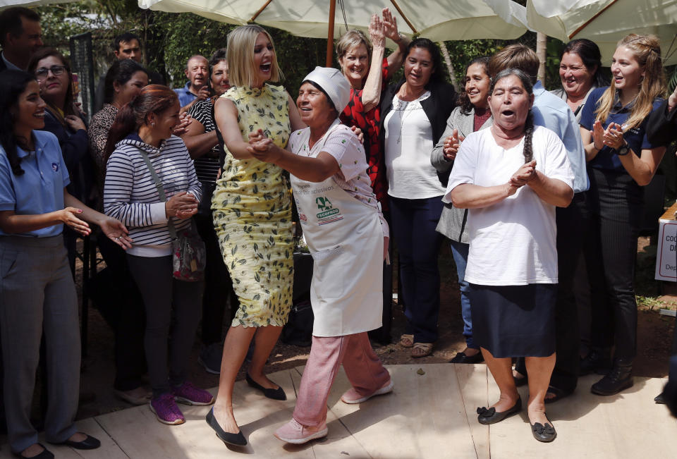 In this Sept. 6, 2019 photo, Ivanka Trump, center left, President Donald Trump's daughter and White Houses advisor, dances with a farmer during a roundtable at El Granel coffee shop in Asuncion, Paraguay. Ivanka Trump is on her third stop of a South American trip to promote women's empowerment. (AP Photo/Jorge Saenz)