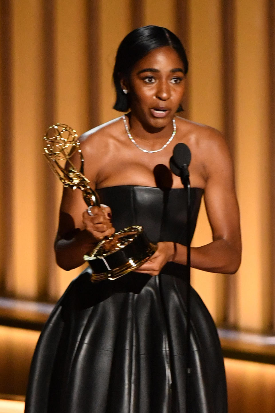 Ayo Edebiri accepting her Emmy award