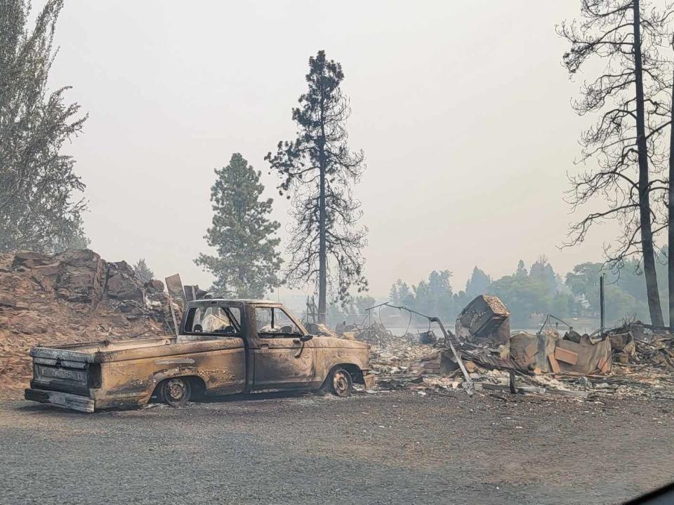 Damaged debris, including a truck with scorch marks.