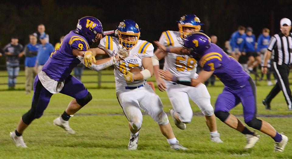 Aberdeen Central's Austin Erickson picks up yardage before being brought down by Watertown defenders Austin Johnson (9) and Marcus Rabine (7) during their Eastern South Dakota Conference football game on Friday, Sept,. 30, 2022 at Watertown Stadium. Aberdeen Central won 17-0.