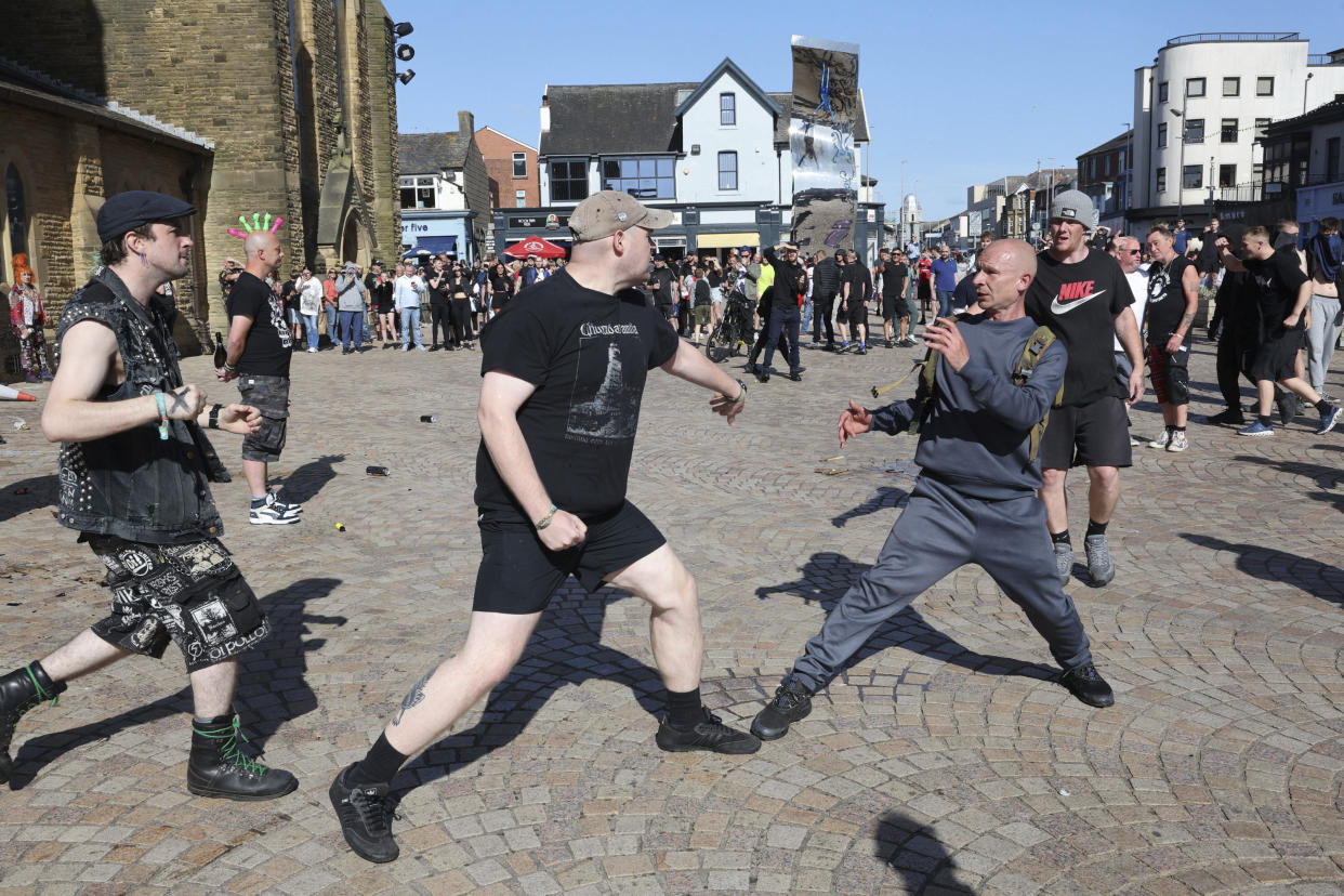 A fight breaks out between antifascists, left, and other people 