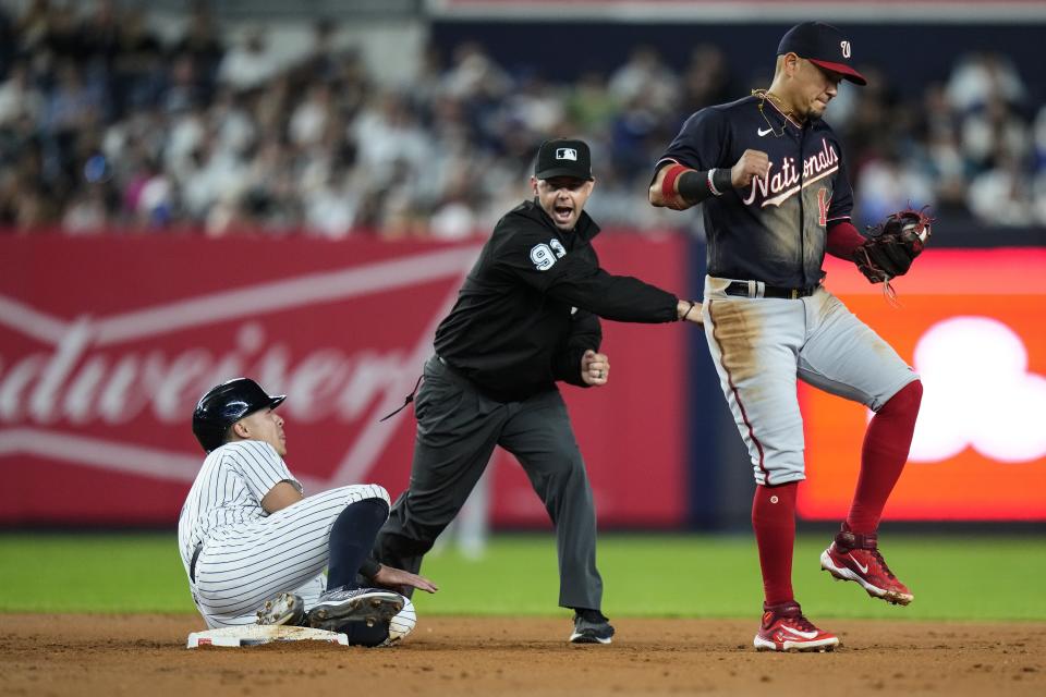 Washington Nationals' Ildemaro Vargas, right, and New York Yankees' Anthony Volpe, left, react as umpire Brian Knight calls Volpe out on an attempted steal of second base during the fourth inning of a baseball game Tuesday, Aug. 22, 2023, in New York. (AP Photo/Frank Franklin II)