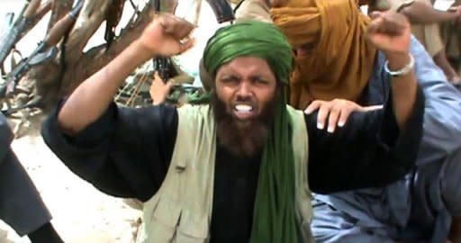 A still from a video shows an Islamist militant celebrating and shouting "Allahu Akbar" (God is Greatest) as an ancient shrine in Timbuktu is destroyed. Islamist rebels smashed the entrance of a 15th-century Timbuktu mosque on Monday, while their Al-Qaeda allies in northern Mali cut off the key city of Gao by planting landmines all around it