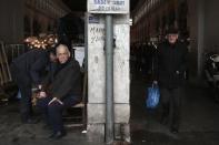 People are seen at the entrance of Athens' main fish market, February 12, 2015. REUTERS/Alkis Konstantinidis