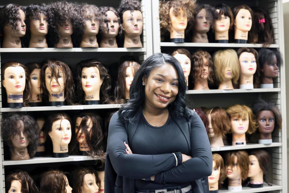 Briana Brown, a cosmetology teacher at Southeastern Regional Vocational Technical High School in Easton, stands with some of the school's manikins on Friday, March 25, 2022.