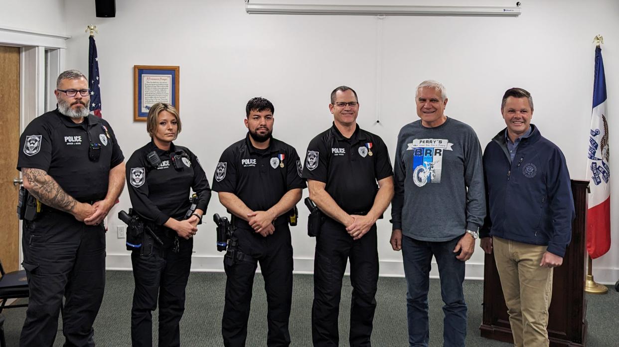School Resource Officer Josh Moore, Officer Micaela Zagar, Officer Cameron Martinez and Chief Eric Vaughn pose for a photo with Mayor Dirk Cavanaugh and U.S. Rep. Zach Nunn after receiving the Iowa Medal of Merit during a ceremony on Friday, April 25, 2024.