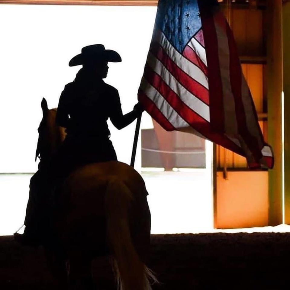 A member of one of the Middle Tennessee State University equestrian teams carries the U.S. flag into the Tennessee Livestock Center during the opening ceremony for the CERV Spring Spectacular Open Show in April 2022.. This year’s benefit horse show will be held from 8 a.m. to 5 p.m. Saturday, April 1, the MTSU’s Tennessee Livestock Center. (Submitted photo by Ashley Foster)