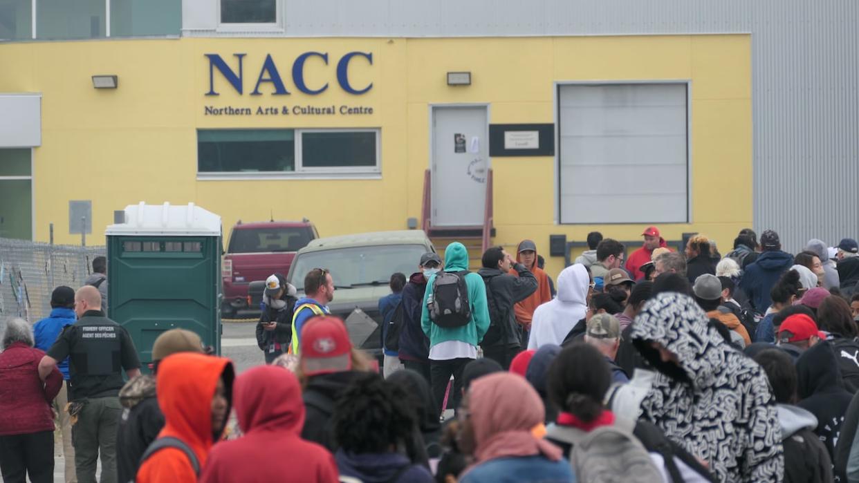 Evacuees without transportation line up to wait for flights out of Yellowknife Thursday.  (Tyson Koschik/CBC - image credit)