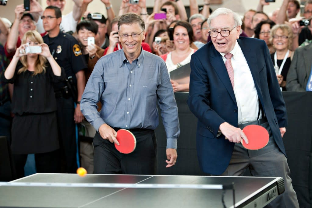 Warren Buffett, chairman of Berkshire Hathaway Inc., right, and Bill Gates, chairman of Microsoft Corp., play table tennis during an event at the annual shareholders meeting in Omaha, Nebraska, U.S., on Sunday, May 6, 2012. Berkshire Hathaway Inc. investment managers Todd Combs and Ted Weschler receive $1 million salaries and can earn more if their bets beat the Standard & Poor's 500 Index, Buffett said Sunday. Photographer: Daniel Acker/Bloomberg via Getty Images