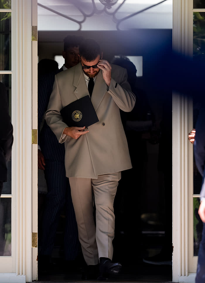 fear of god suit, WASHINGTON, DC - MAY 31: NFL Kansas City Chiefs tight end Travis Kelce walks out of the Palm Room into the Rose Garden following an event with U.S. President Joe Biden on the South Lawn of the White House on May 31, 2024 in Washington, DC. President Biden hosted the Chiefs to honor their 2024 Super Bowl win. (Photo by Andrew Harnik/Getty Images)