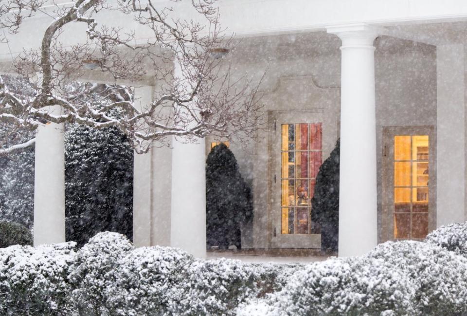 In the midst of a snowstorm, Obama works at his desk in the Oval Office on Jan. 22.