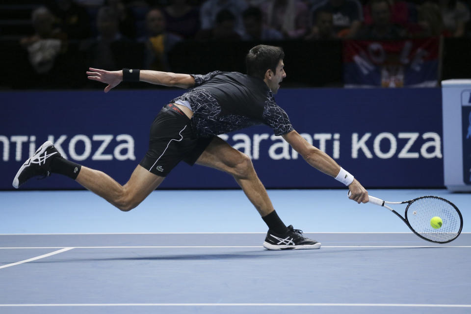 El serbio Novak Djokovic alcanza una pelota para devolverla de revés al estadounidense John Isner en su partido inicial de la Copa Master en la Arena O2, en Londres, el lunes 12 de noviembre de 2018. (AP Foto/Tim Ireland)