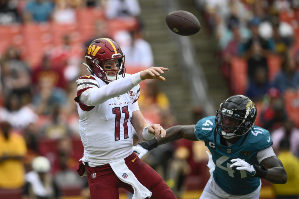 Washington Commanders quarterback Carson Wentz (11) throws the ball against Jacksonville Jaguars linebacker Josh Allen (41) during the second half of an NFL football game, Sunday, Sept. 11, 2022, in Landover, Md. (AP Photo/Nick Wass)
