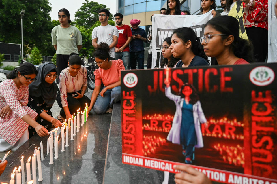 Medical professionals light candles as they  pay tribute to a   young medic from Kolkata who was the victim of a rape and murder, during a demonstration in Amritsar, India, Aug. 18, 2024. / Credit: NARINDER NANU/AFP/Getty