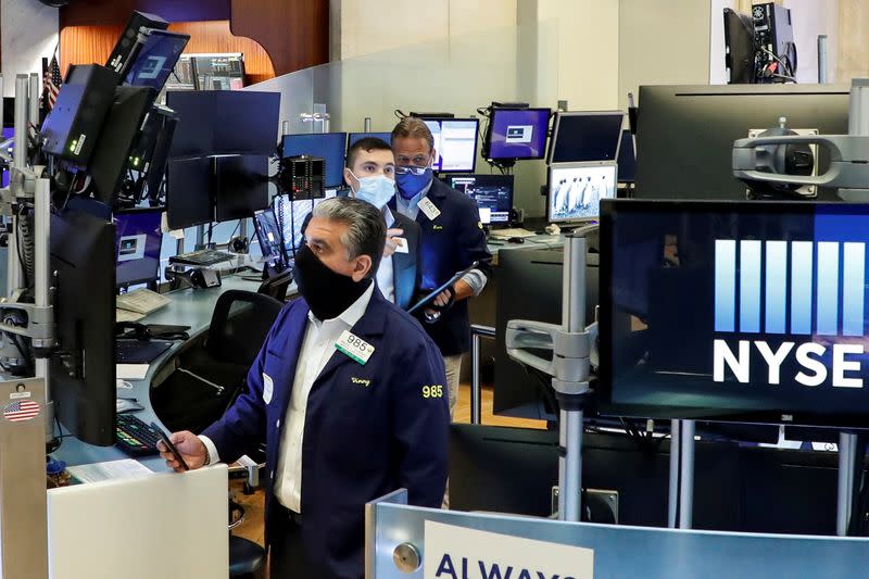 FILE PHOTO: Traders at the New York Stock Exchange during the coronavirus pandemic