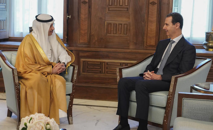 In this photo released by the official Facebook page of the Syrian Presidency, Syrian President Bashar Assad, right, meets with Saudi Arabia ambassador to Jordan Nayef al-Sadiri, in Damascus, Syria, Wednesday, May 11, 2023. Assad Wednesday received an invitation from Saudi Arabia to attend the upcoming Arab League summit at the oil-rich kingdom, the Syrian president's office said in a statement. the invitation days after the Arab League restored Syria's membership into the organization in Cairo, Egypt, on Sunday, after it was suspended in 2011 for the country's brutal crackdown on pro-democracy protesters. (Syrian Presidency Facebook page via AP)