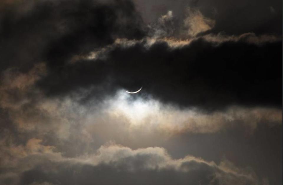 Clouds partially cover a solar eclipse visible from the northern tip of Australia in 2012. Partially cloudy skies are expected along the Mississippi Coast during Monday’s solar eclipse.