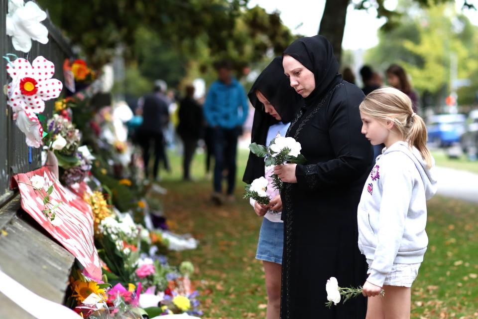 Members of the Muslim community lay flowers at the memorial wall at the Botanic Gardens on March 17, 2019 in Christchurch, New Zealand. 50 people are confirmed dead, with dozens injured still in hospital following shooting attacks on two mosques in Christchurch on Friday, March 15th.
