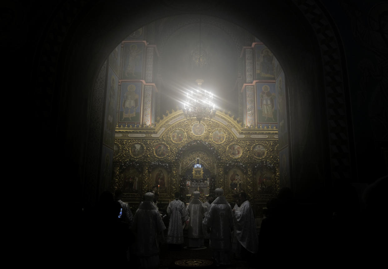 Ukrainian priests holding a service before the start of the Orthodox Chrismas in the St. Michael's Monastery of Kyiv, Ukraine, Friday, Jan. 6, 2023. Russian President Vladimir Putin on Thursday ordered Moscow's armed forces to observe a 36-hour cease-fire in Ukraine this weekend for the Russian Orthodox Christmas holiday, but Ukrainian President Volodymyr Zelenskyy questioned the Kremlin's intentions, accusing the Kremlin of planning the fighting pause "to continue the war with renewed vigor". (AP Photo/Bela Szandelszky)