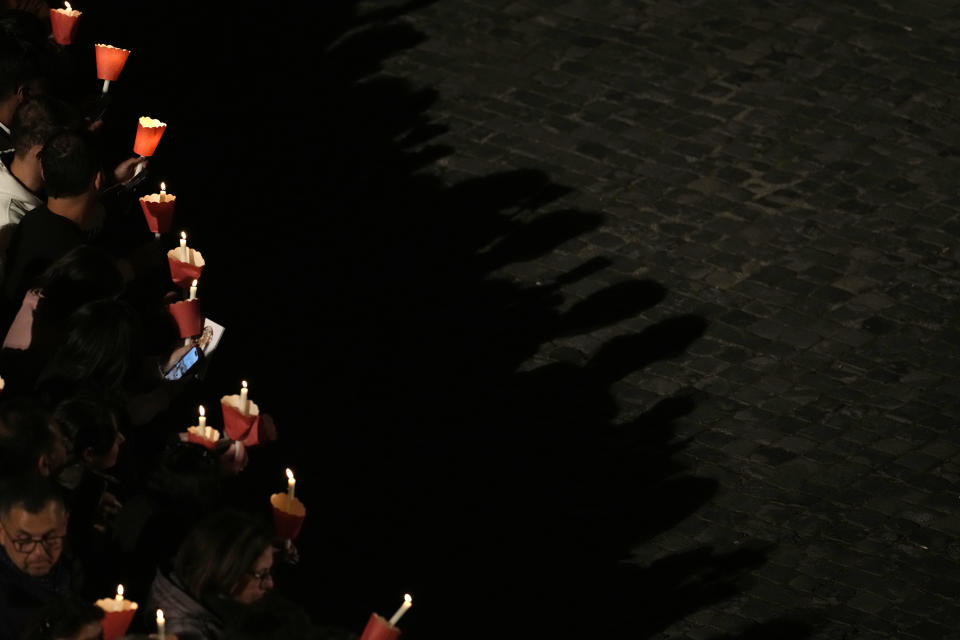 Faithful hold candles as they take part in the Via Crucis (Way of the Cross) torchlight procession at the Colosseum on Good Friday, in Rome, Friday, March 29, 2024. (AP Photo/Andrew Medichini)