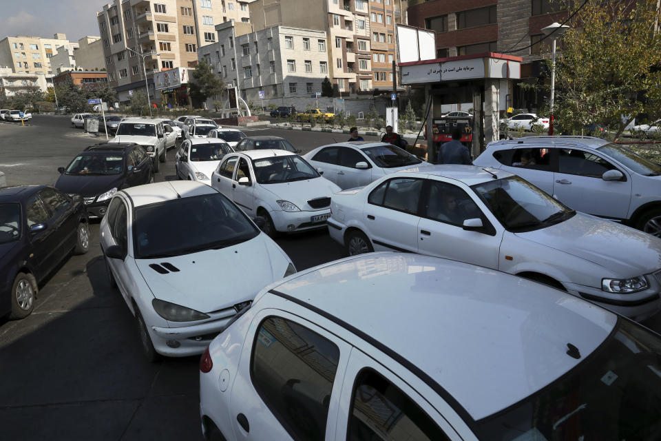 Vehicles queue to enter a gas station in Tehran, Iran, Friday, Nov. 15, 2019. Authorities have imposed rationing and increased the prices of fuel. The decision came following months of speculations about possible rationing after the U.S. in 2018 reimposed sanctions that sent Iran's economy into free-fall following Washington withdrawal from 2015 nuclear deal between Iran and world powers. (AP Photo/Vahid Salemi)