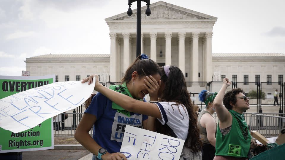 Abortion rights activists Carrie McDonald, left, and Soraya Bata react to the ruling which overturned the landmark Roe v. Wade abortion decision outside the US Supreme Court on June 24, 2022, in Washington. - Anna Moneymaker/Getty Images