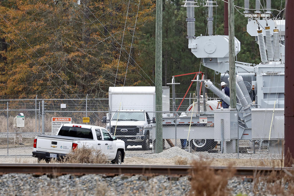 Workers work on equipment at the West End Substation, at 6910 NC Hwy 211 in West End, N.C., Monday, Dec. 5, 2022, where a serious attack on critical infrastructure has caused a power outage to many around Southern Pines, N.C. (AP Photo/Karl B DeBlaker)