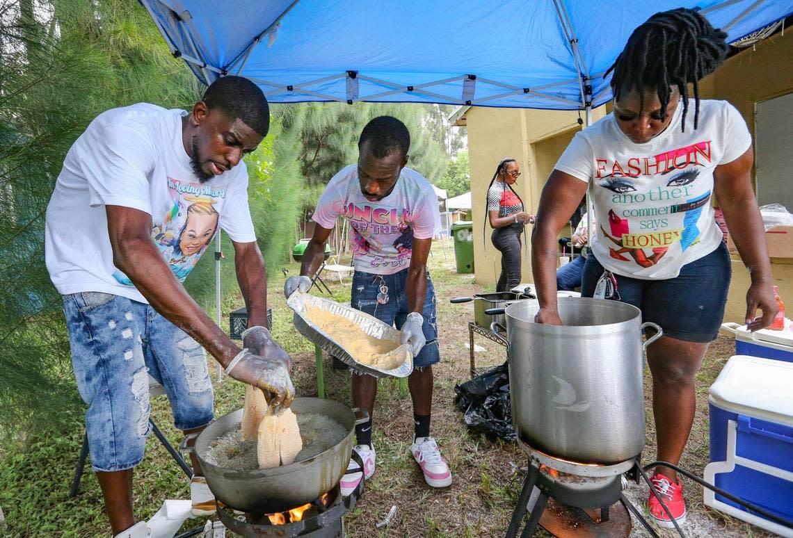 Seven months after a tragic hit-and-run in Wilton Manors that killed Laziyah Stukes, 10, two other girls and left several children injured, Stukes mother, Devera Stukes, holds a balloon release and fish fry to help raise money to pay for her daughter’s funeral. Andre Fleming, Noble Williams and Chelsea King, l to r, prepare food as friends and family gather at the Fort Lauderdale home on Saturday, July 16, 2022.
