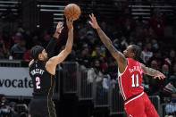 Miami Heat guard Gabe Vincent, left, shoots over Chicago Bulls forward DeMar DeRozan during the first half of an NBA basketball game in Chicago, Saturday, Nov. 27, 2021. (AP Photo/Nam Y. Huh)