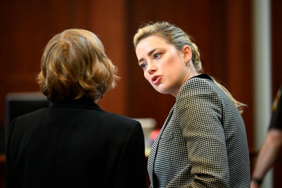 Amber Heard speaks with her attorney Elaine Bredehoft (AP)