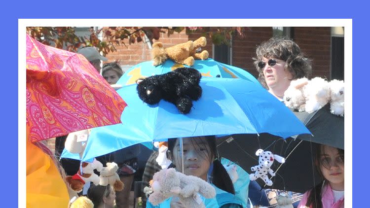 kids in halloween parade wearing raining cats and dogs costumes