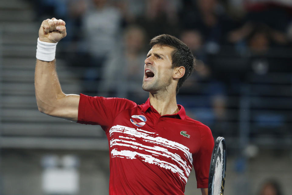 Novak Djokovic of Serbia reacts to winning a point against Rafael Nadal of Spain during their ATP Cup tennis match in Sydney, Sunday, Jan. 12, 2020. (AP Photo/Steve Christo)