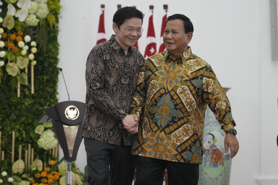 Indonesian Defense Minister and president-elect Prabowo Subianto, right, shakes hands with Singapore's Deputy Prime Minister and Finance Minister Lawrence Wong at Bogor Presidential Palace in Bogor, Indonesia, Monday, April 29, 2024. (AP Photo/Achmad Ibrahim)