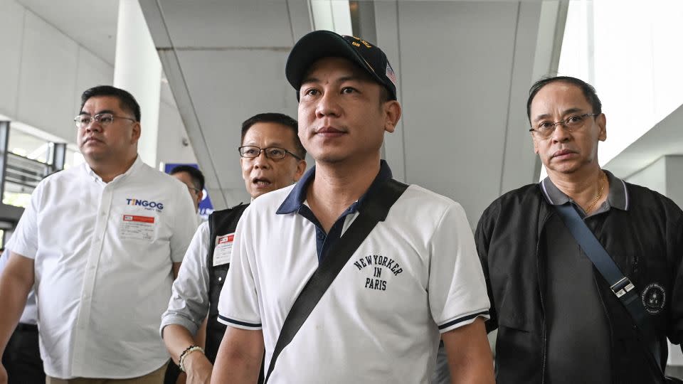 Christian Domarique (center), a crew member of the MV Tutor, arrives in Metro Manila, on June 17. Dozens of ships have been attacked in the Red Sea, as regional tensions flare over Israel's war in Gaza. - Jam Sta Rosa/AFP/Getty Images