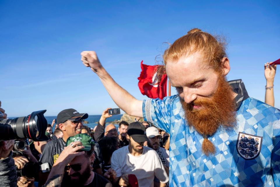 Russ celebrating as he passes the finish line. (Copyright 2024 The Associated Press. All rights reserved.)